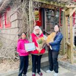 From left: Tara Kanagaraj holds the 2026 Stewardship of a Community Asset Award won by the Whonnock Post Office, former postmaster Sue Schulze, new postmaster Mareesa Kelly holding honorary postmaster Sid. (Special to The News)
