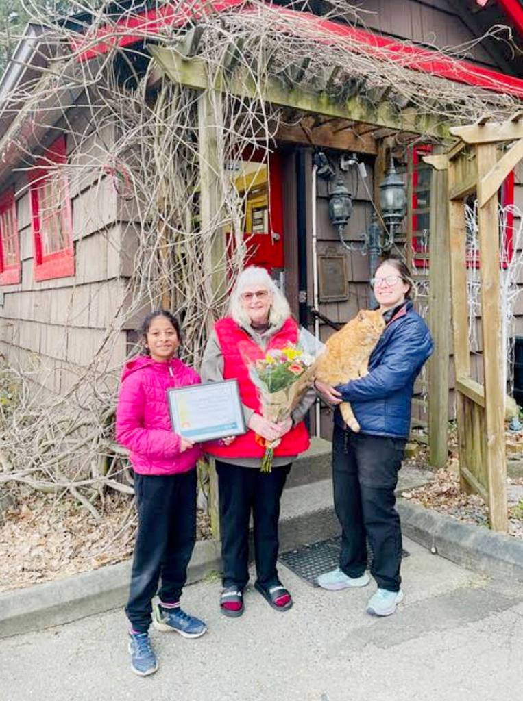 From left: Tara Kanagaraj holds the 2026 Stewardship of a Community Asset Award won by the Whonnock Post Office, former postmaster Sue Schulze, new postmaster Mareesa Kelly holding honorary postmaster Sid. (Special to The News)